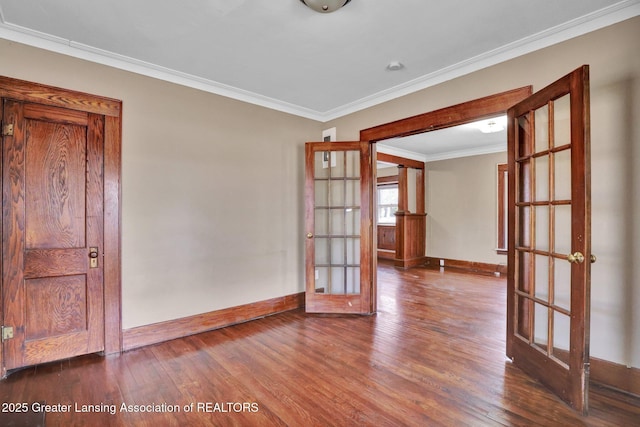 empty room with baseboards, french doors, wood finished floors, and crown molding