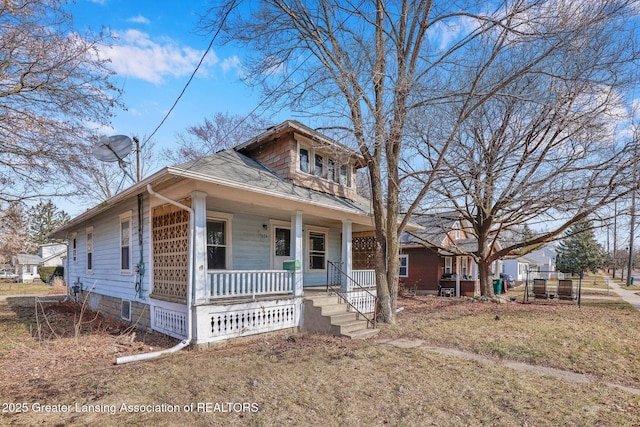 view of front of property with a shingled roof and covered porch