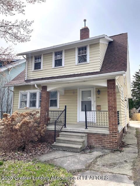 view of front of property featuring a porch and a chimney