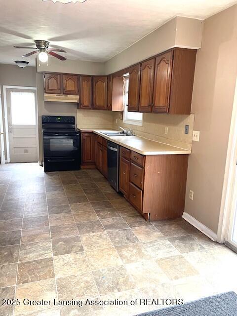 kitchen featuring light countertops, electric range, a sink, under cabinet range hood, and dishwashing machine