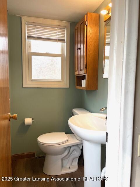 bathroom with toilet and baseboards