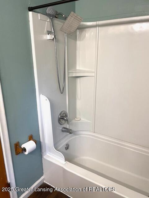 full bath with  shower combination and baseboards