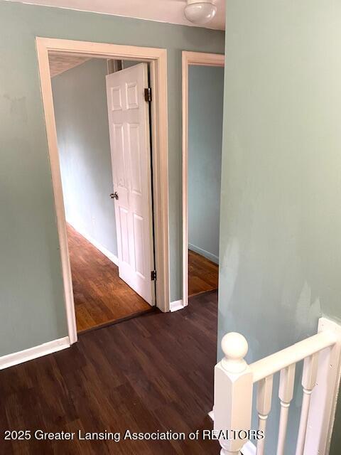 hall with wood finished floors and baseboards