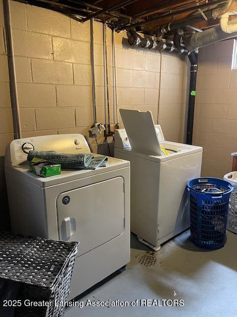 clothes washing area featuring laundry area and separate washer and dryer