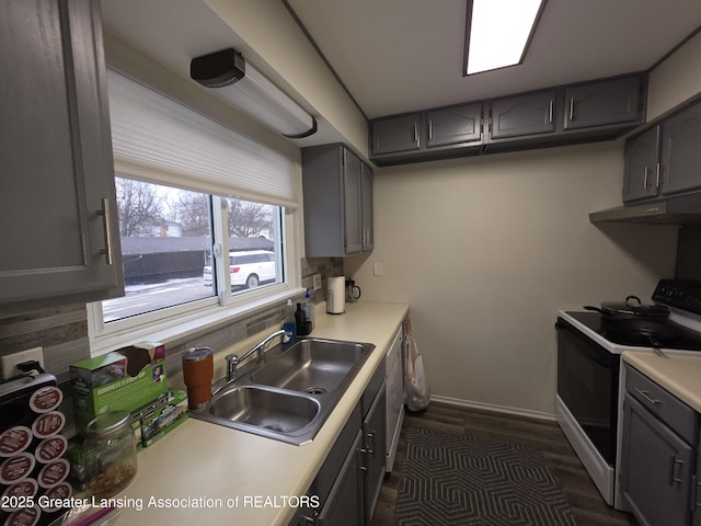 kitchen with range with electric cooktop, a sink, gray cabinets, under cabinet range hood, and backsplash