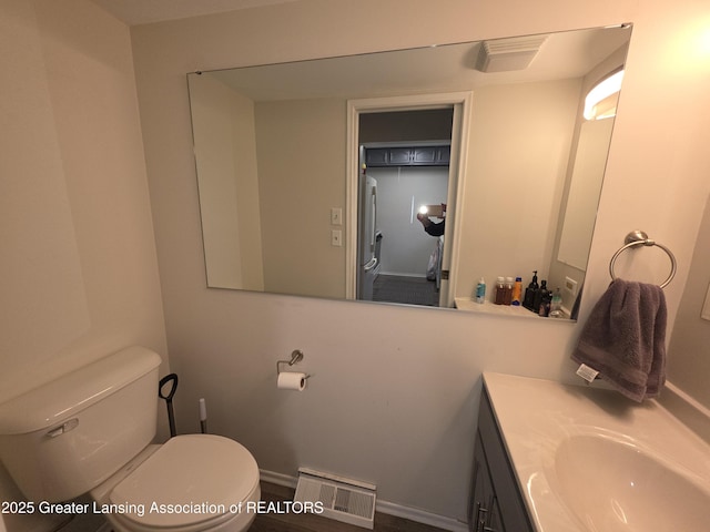 bathroom with toilet, visible vents, and vanity