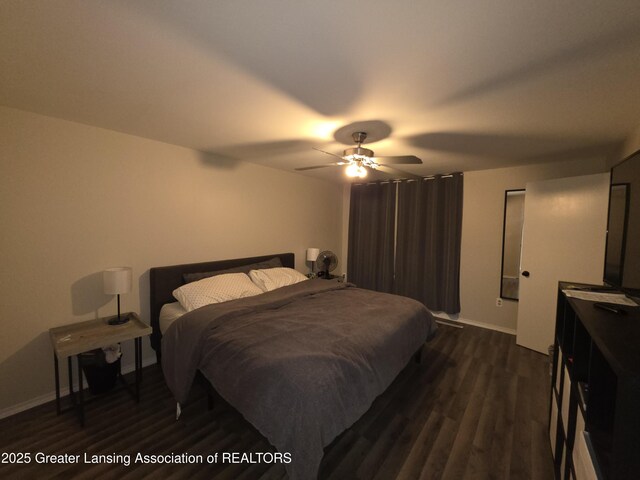 bedroom featuring a ceiling fan, dark wood finished floors, and baseboards