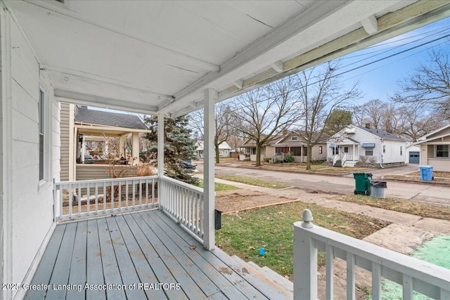 wooden deck with covered porch and a residential view