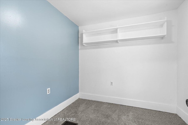 carpeted spare room with baseboards