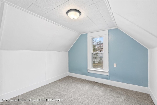 additional living space with lofted ceiling, carpet, and baseboards