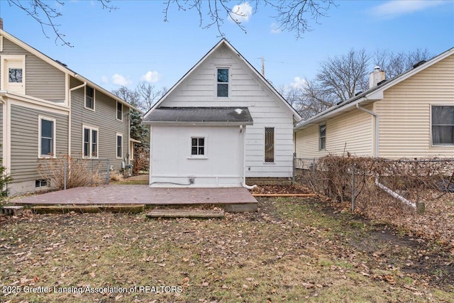 back of house with fence and an outdoor structure