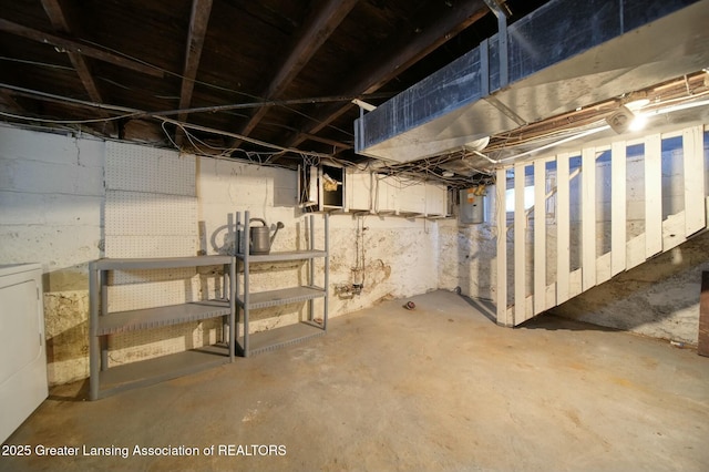 unfinished below grade area featuring washer / dryer and electric panel