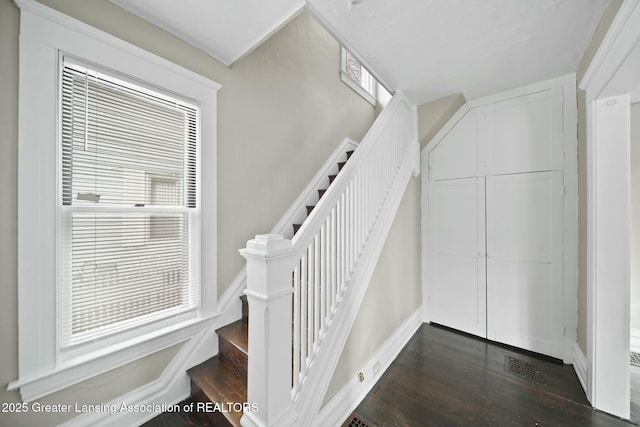 stairs featuring baseboards and wood finished floors