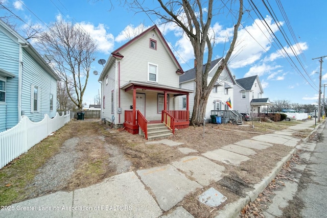 view of front facade with a porch and fence