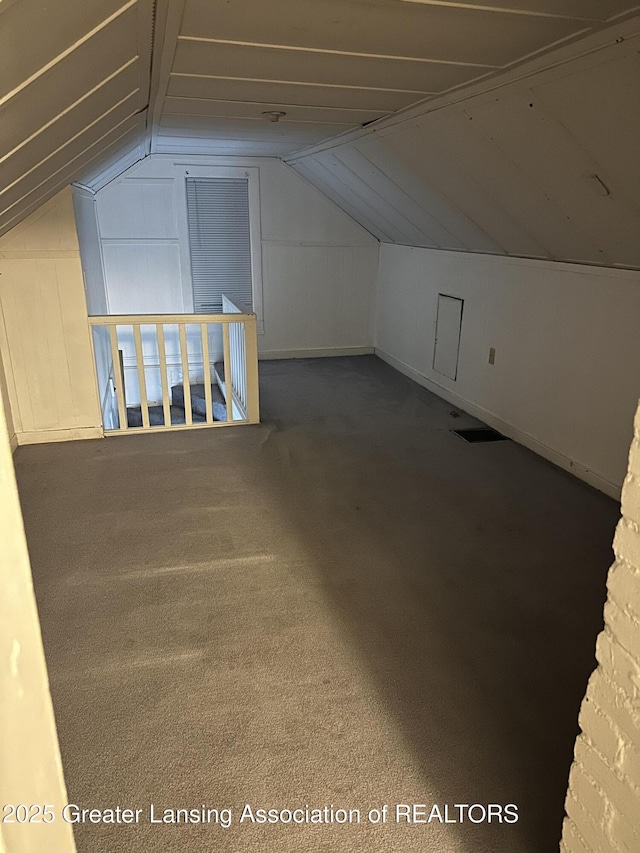 additional living space with carpet and vaulted ceiling