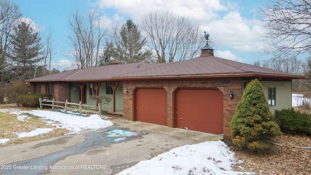 view of front of home featuring a garage, driveway, brick siding, and a porch