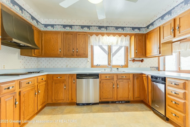 kitchen with cooktop, brown cabinetry, stainless steel dishwasher, under cabinet range hood, and a sink