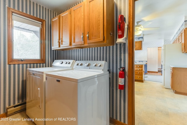 laundry room featuring wallpapered walls, ceiling fan, cabinet space, and independent washer and dryer