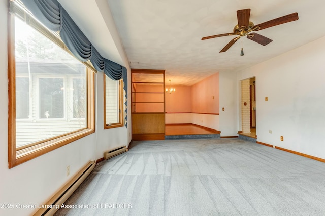 unfurnished living room with a baseboard radiator, light colored carpet, and a healthy amount of sunlight