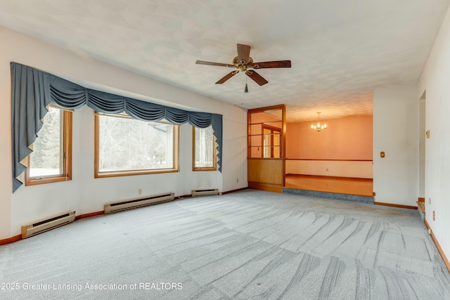 carpeted spare room with baseboards, baseboard heating, and ceiling fan with notable chandelier