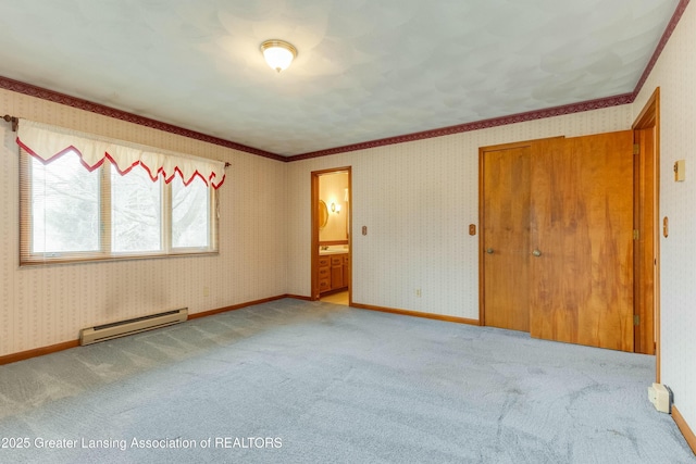 spare room with carpet floors, baseboards, baseboard heating, and wallpapered walls