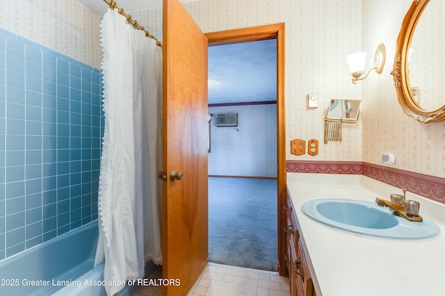 full bath featuring a wall mounted air conditioner, shower / bath combination with curtain, vanity, and wallpapered walls