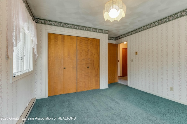 unfurnished bedroom featuring carpet floors, a baseboard radiator, a closet, and wallpapered walls