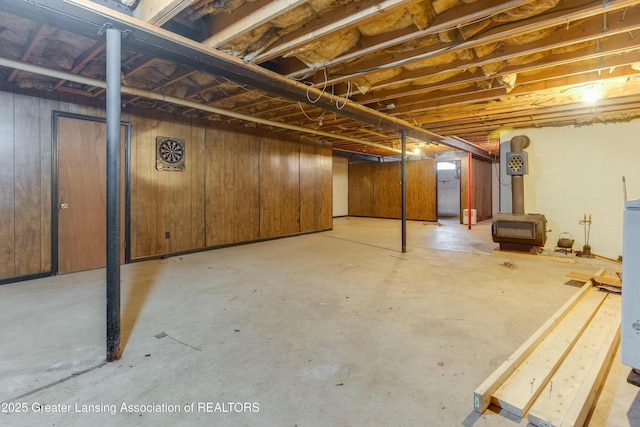 unfinished basement featuring concrete block wall