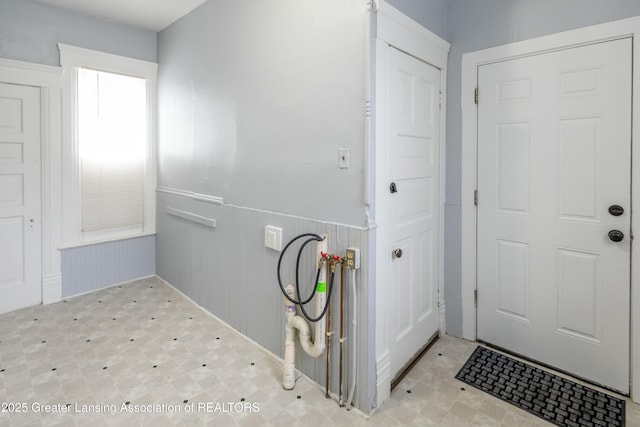 laundry room with hookup for a washing machine, a wainscoted wall, tile patterned floors, and laundry area