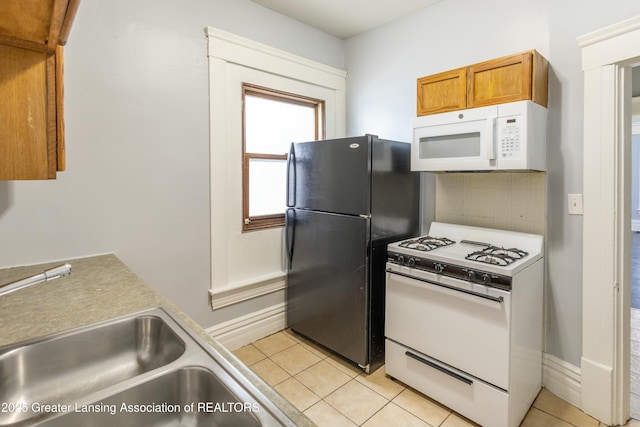 kitchen featuring light tile patterned floors, brown cabinets, white appliances, and light countertops