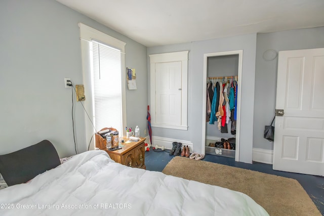 bedroom featuring baseboards and a closet