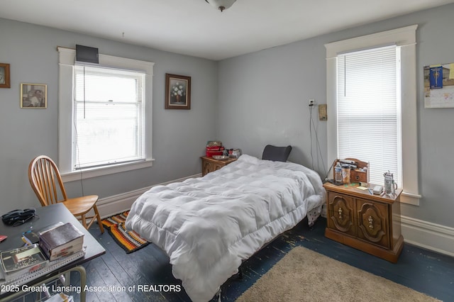 bedroom with baseboards and wood finished floors