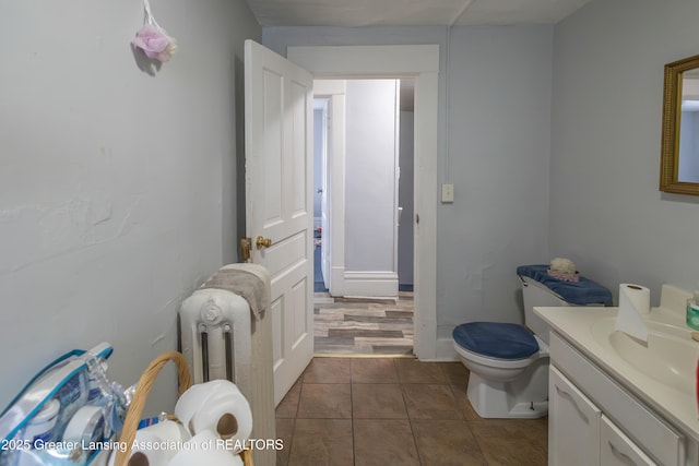 bathroom with tile patterned floors, toilet, and vanity