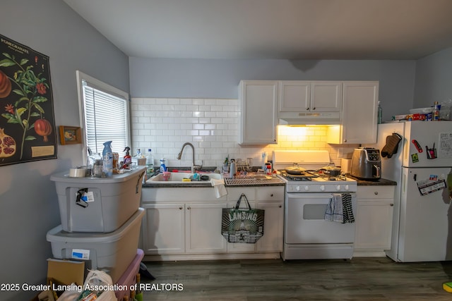 kitchen with white appliances, white cabinets, backsplash, and a sink