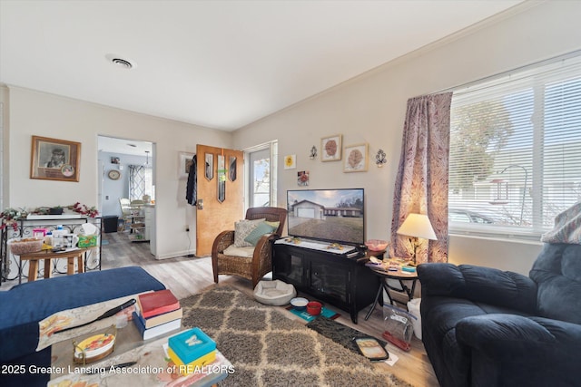 living area with wood finished floors and visible vents