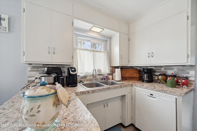 kitchen featuring white dishwasher, backsplash, a sink, and light countertops