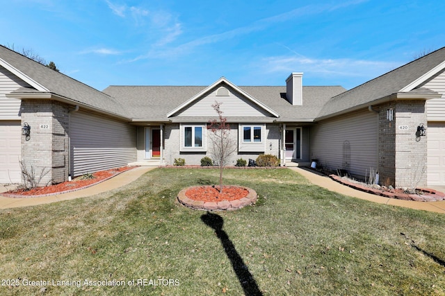 ranch-style home featuring a front yard, brick siding, and a garage