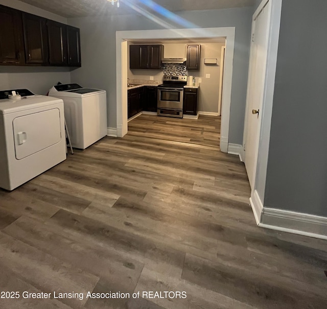 laundry room with washer and dryer, wood finished floors, cabinet space, and baseboards