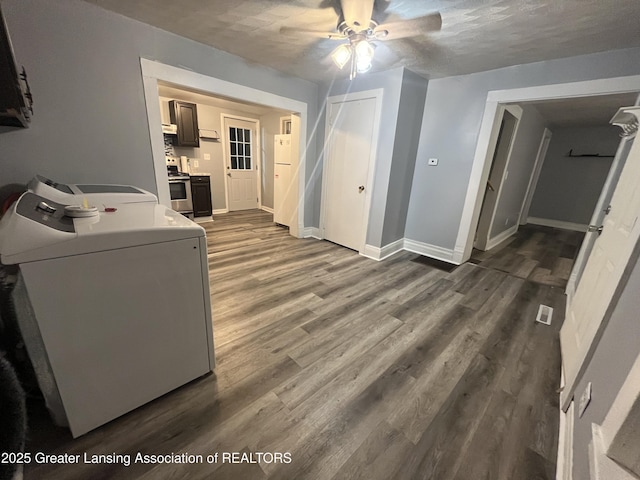 laundry room featuring visible vents, baseboards, dark wood finished floors, laundry area, and washer / dryer