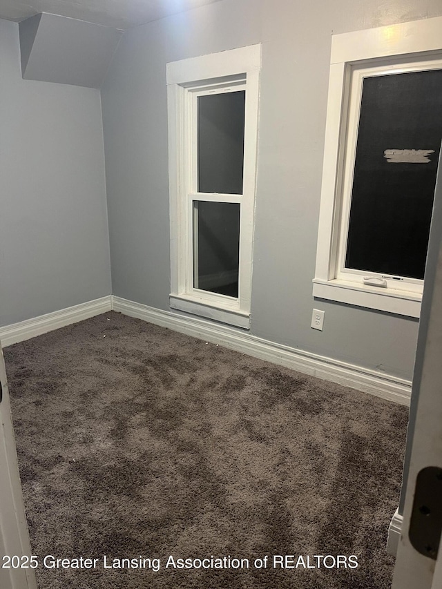 empty room featuring baseboards and carpet floors