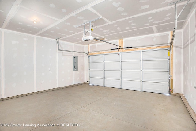 garage with a garage door opener and electric panel