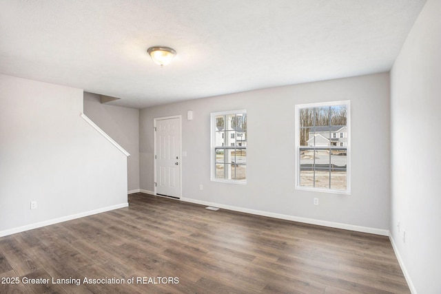 entryway with baseboards and wood finished floors