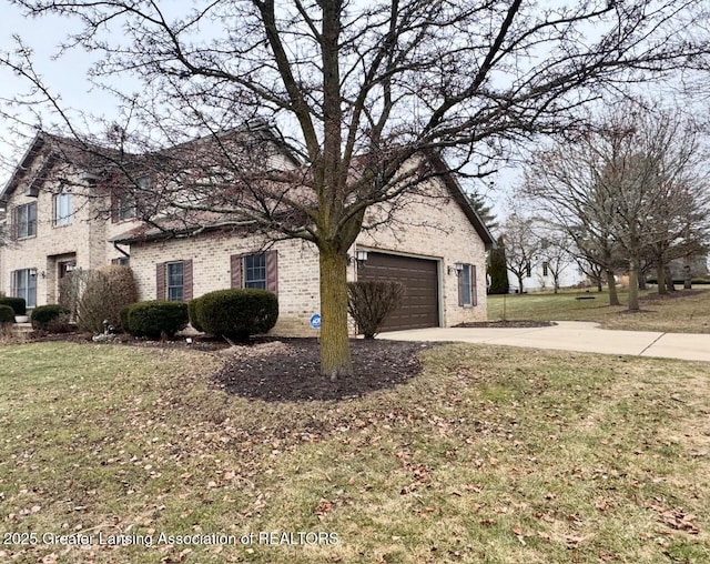 view of front of home with driveway, brick siding, an attached garage, and a front yard