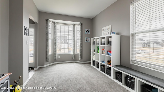 interior space with carpet flooring and baseboards