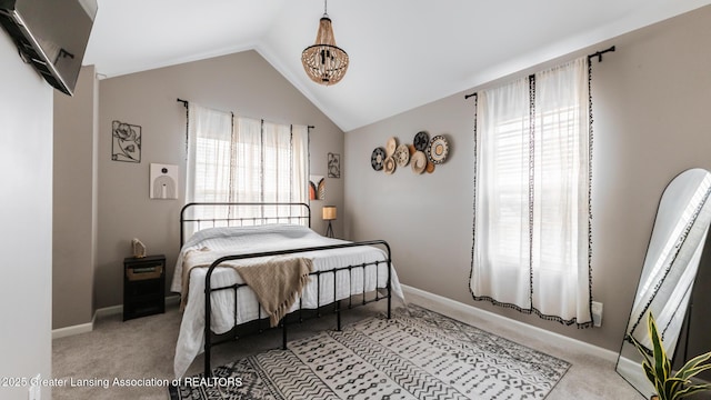 bedroom with light carpet, vaulted ceiling, and baseboards