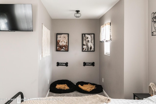 bedroom with carpet flooring and baseboards