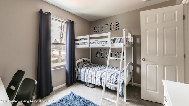 carpeted bedroom featuring baseboards