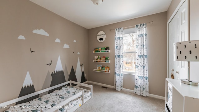 interior space with visible vents, baseboards, a closet, and light colored carpet