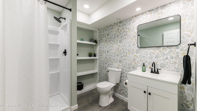 bathroom with curtained shower, wood finished floors, toilet, and wallpapered walls