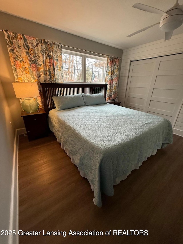 bedroom featuring a closet, wood finished floors, and a ceiling fan